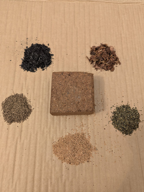 Compost Cube coco brick surrounded by five ingredient samples