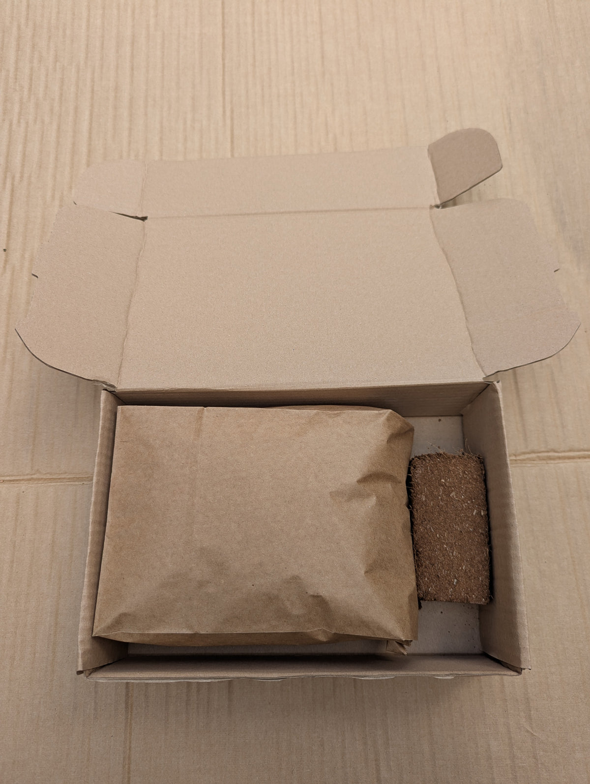 Compost Cube box open showing Bag of Goodness and coco brick